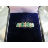 9ct yellow gold ring set with oval-cut emeralds and round-cut diamonds, boxed