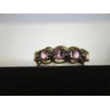Ornate 9ct yellow gold ring set with oval-cut pink sapphires and round-cut diamonds