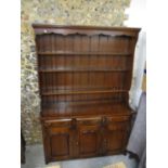 A late 20th century oak dresser with three shelves, over three drawers and three doors 200cm h x