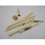 A small collection of early 20th century ivory cigarette holders, to include an example with