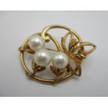 A 14ct gold and pearl brooch with scroll and foliate details, 3.5 cm wide, 7.3 g