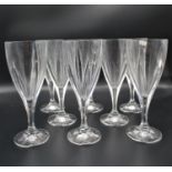 A set of eight Renwick & Clarke red wine lead crystal goblets, with oblong faceted bodies, on