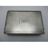 A George V silver cigarette box by William Base & Sons, Birmingham 1928, of rectangular form with