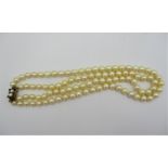 A double stranded cultured pearl necklace with 9ct gold clasp inset with garnets, 43 cm long