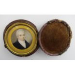 A British miniature portrait of a gentleman on ivory, English School, 19th century, of circular form