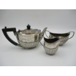 A George V silver bachelor's tea set by William Hutton and Sons, London 1916, comprising a teapot, a