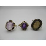 A small collection of dress rings, to include two 9 ct gold and amethyst rings and a brown topaz