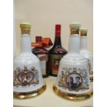 One bottle of Cointreau, one bottle of Tia Maria and three Wade Bells porcelain decanters (two