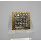 A yellow metal and diamond gents ring, in the signet style, set with twenty five diamonds, with