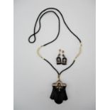 An Art Deco style jet, yellow metal and pearl parure, comprising a necklace and pair of earrings,
