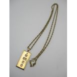 A 9ct gold ingot pendant together with a 9ct gold rope style chain, 88 cm long, combined weight 37 g