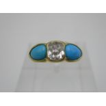 A diamond, turquoise and yellow metal dress ring, the cushion cut diamond to the centre flanked with