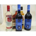 Two bottles of Harvey's Solera Sherry and one bottle of Smirnoff, along with two bottles of Famous