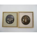 A 19th century Japanese kinko tsuba, in shibuishi, with raised silver details of a rodent and an