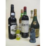 Eight bottles of mixed spirits and wine to include Chateau D Angludet Margaux 1980 and Cognac