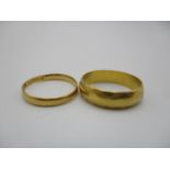 Two 22ct gold wedding bands, the larger one with hammered effect, sizes L and J, combined weight 5 g
