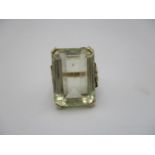 A 9ct gold and pale citrine dress ring, the large central stone with emerald cut, size J