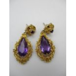 A pair of yellow metal and amethyst drop earrings, with teardrop shaped amethysts and pierced gilt
