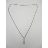An 18ct white gold and diamond pendant, hanging on an 18ct white gold spiga chain, the pendant