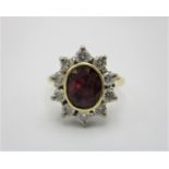 An 18ct gold, ruby and diamond cluster ring, set with ten round brilliant cut diamonds (approx. 0.
