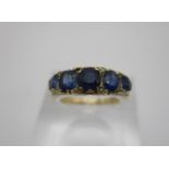 An 18ct gold and five stone sapphire ring, with graduated oval sapphires, the largest one 0.5 mm