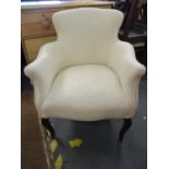 A cream upholstered arm chair with front cabriole legs
