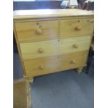 An early 20th century stripped pine chest of two short and two long drawers on turned legs