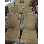 A set of eight wrought iron and wicker conservatory dining chairs