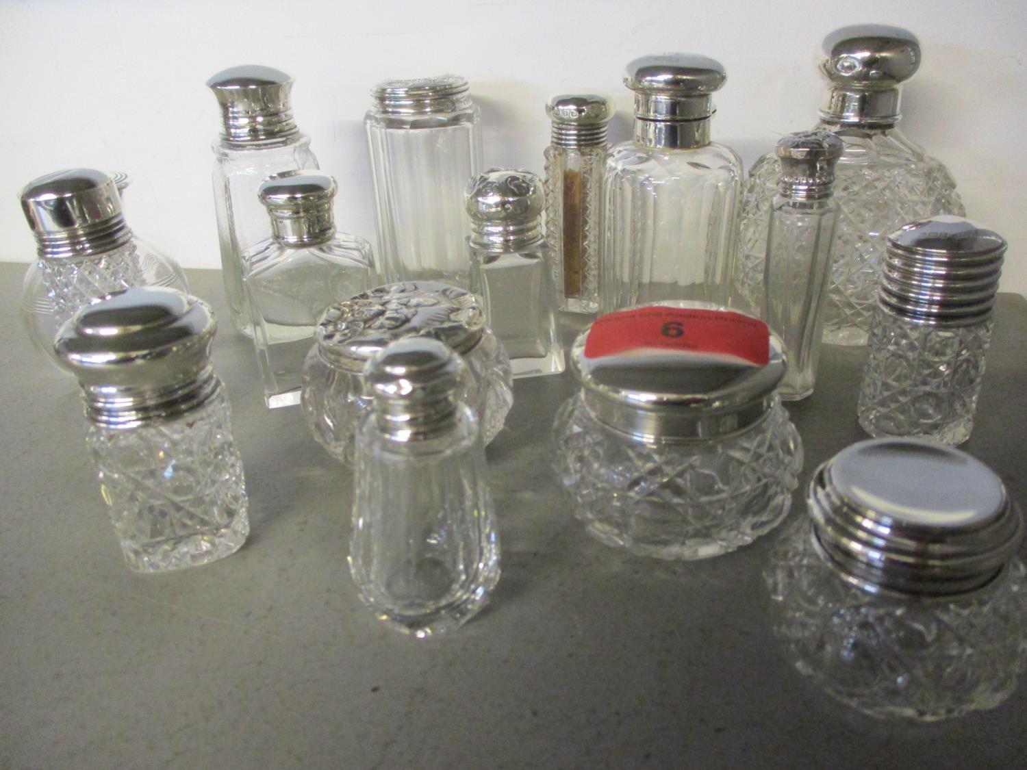 A collection of silver and silver plated topped cut glass dressing table pots (16)