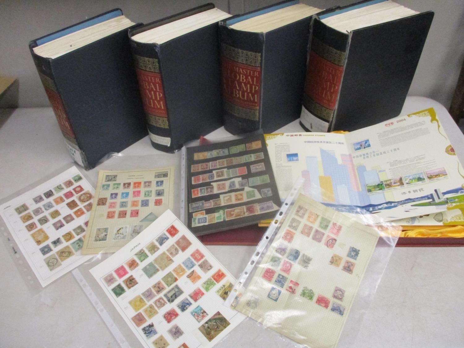 Postage stamps from around the world to include four The Master Global stamp albums with various