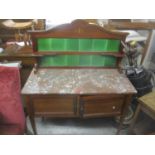 An Edwardian mahogany marble topped wash stand having a tile back and two cupboard doors below 135cm