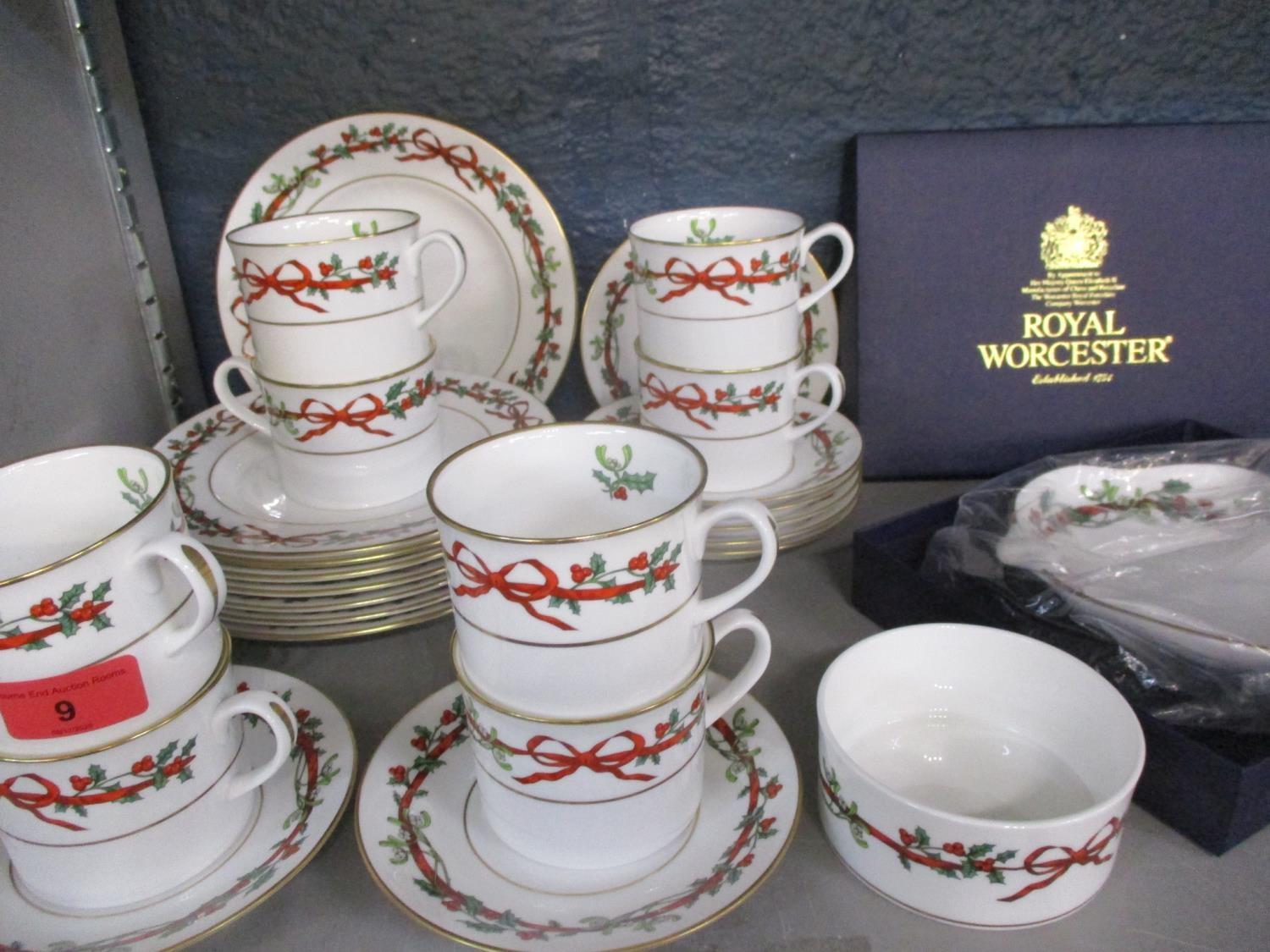 A Royal Worcester Christmas set comprising eight cups and saucers, eight tea plates, a sugar bowl