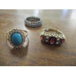 A 9ct gold garnet and white sapphire ring, a yellow metal turquoise cabochon ring surrounded by