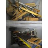 A selection of tools to include saws, clamps, drill bit and other mixed tools