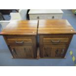 A pair contemporary exotic wood bedside cabinets each with a single drawer above a cupboard door