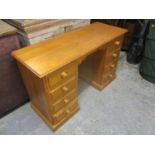 A modern pine eight drawer twin pedestal desk 74h x 141cm w