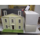 A large dolls house together with two boxed dolls entitled 'Sitting Pretty' and 'Baby's First Year'