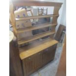 A Victorian pine dresser having an open plate rack above two drawers and cupboard doors 216cm h x