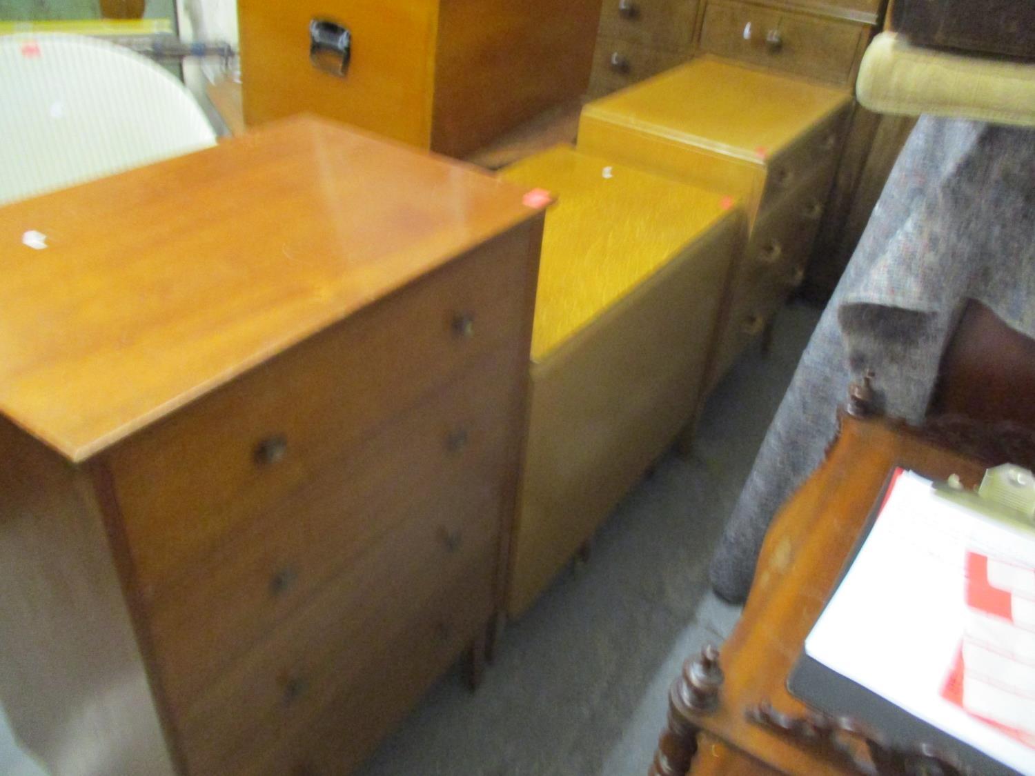 A mid century chest of three graduated drawers, a teak chest of four drawers with round gilt metal