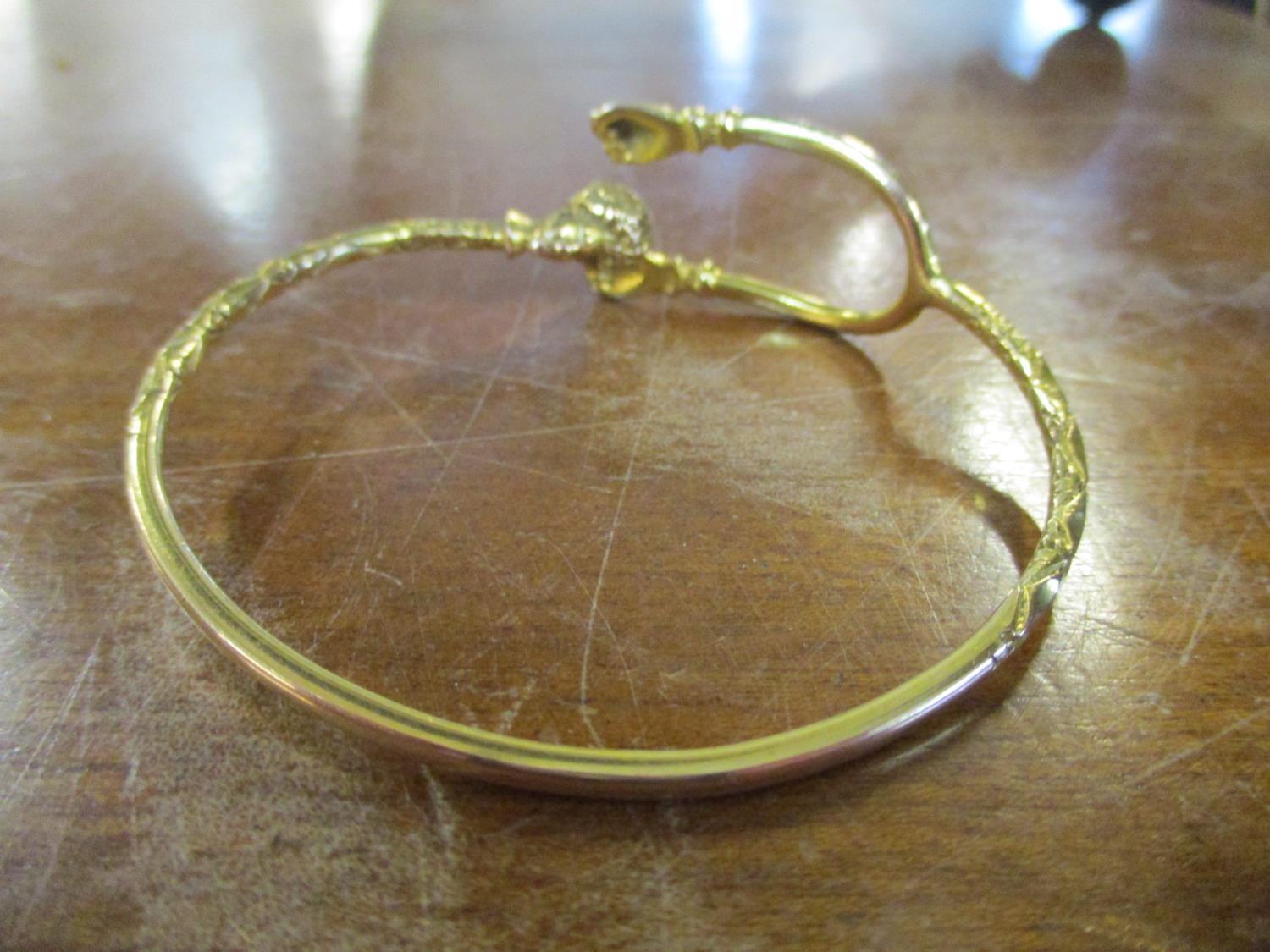 A yellow metal bracelet, the forked and terminating in two clenched fists, the other and terminating - Image 2 of 3