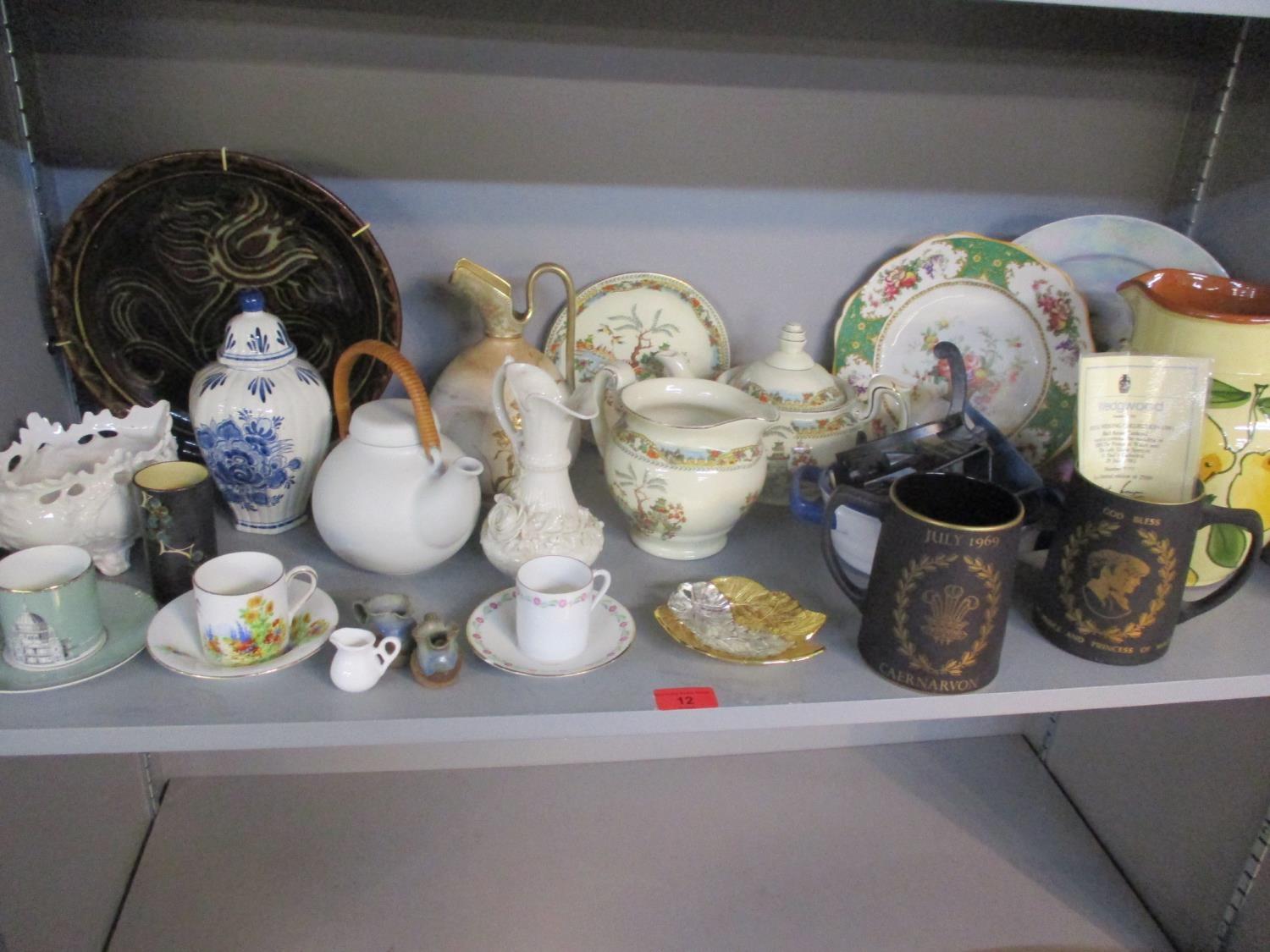 A Belleek black stamp jug, two Wedgwood black basalt commemorative tankards, a studio pottery