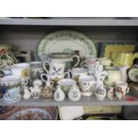 A collection of jugs and loving cups to include Victorian and commemorative examples, an Emma