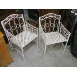 A pair of modern cream painted metal folding chairs