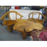 A polished teak root coffee table 54 h x 90cm w and a pair of chairs
