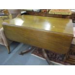 A 20th century mahogany drop leaf dining table on quadrofoil base 75 h x 65 d x 107cm w (unextended)