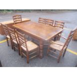 A reproduction oak Titchmarsh & Goodwin extending dining table, together with a set of eight oak