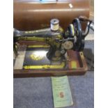 A 1920 Singer sewing machine in oak travel case, serial number Y119320