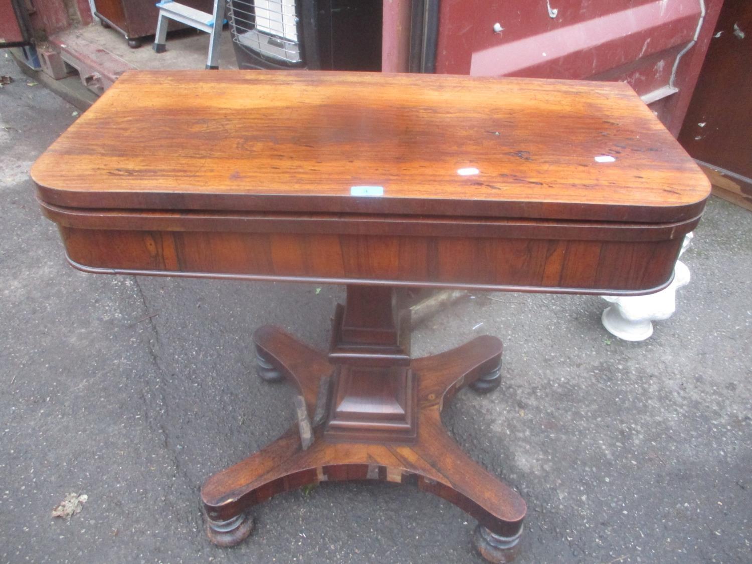 A William IV rosewood foldover card table on a quatrefoil base with turned feet 78cm h x 90.5cm w