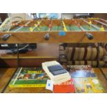 A vintage Italian Arcofalc football table with a red shirt team and a yellow shirt team, together