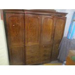 A large Victorian mahogany breakfront sectional wardrobe having two long doors flanking two short